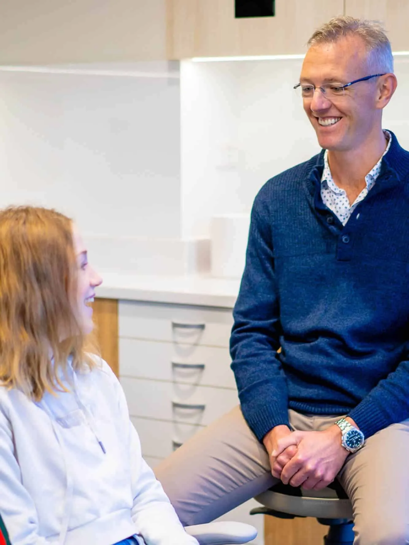 Orthodontist smiling with a young patient in a Central Coast Orthodontics treatment room