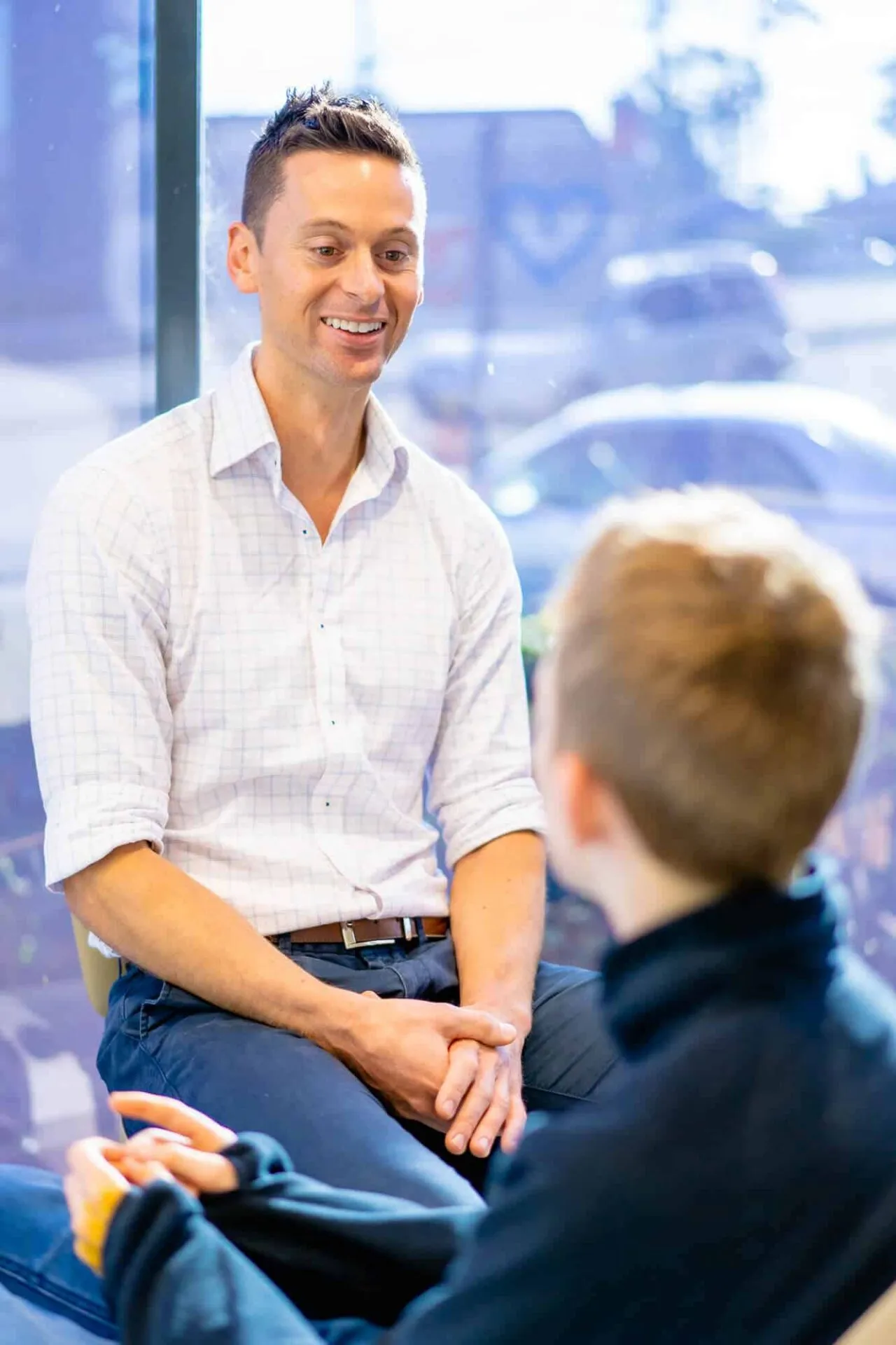 Orthodontist talking with a young boy during a consultation at Central Coast Orthodontics