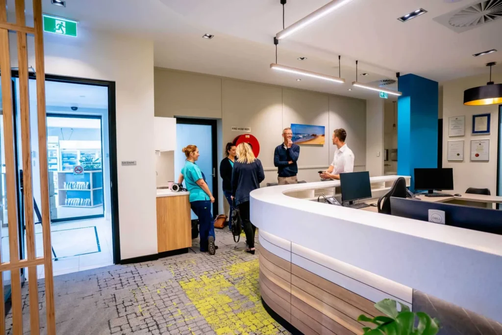 Patients waiting and staff working at the Central Coast Orthodontics reception counter