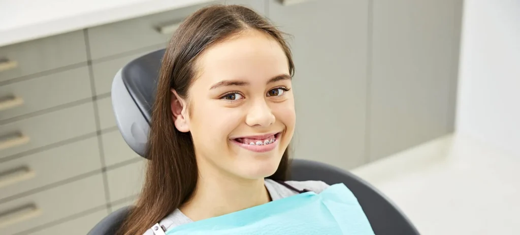 Teenage girl smiling in the dental chair