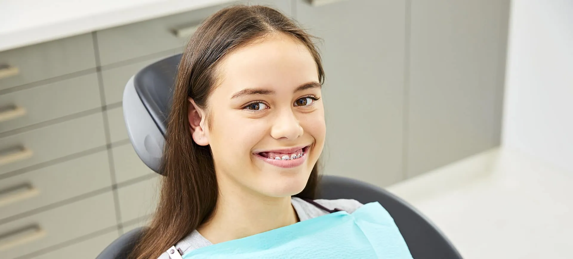 Teenage girl smiling in the dental chair