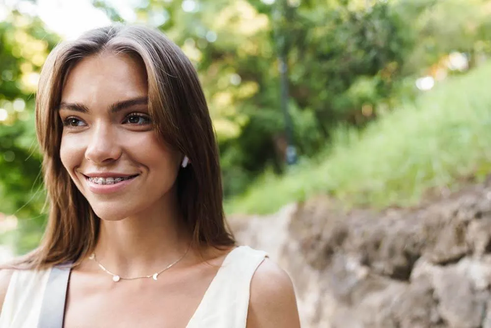 Young woman with braces smiling outdoors