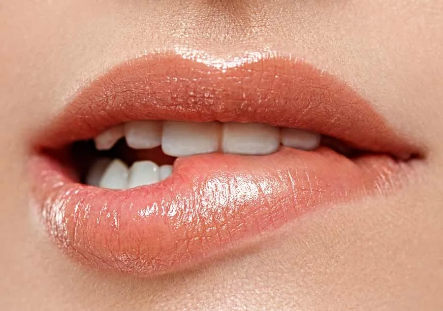 Close-up of parted lips showing the upper and lower front teeth